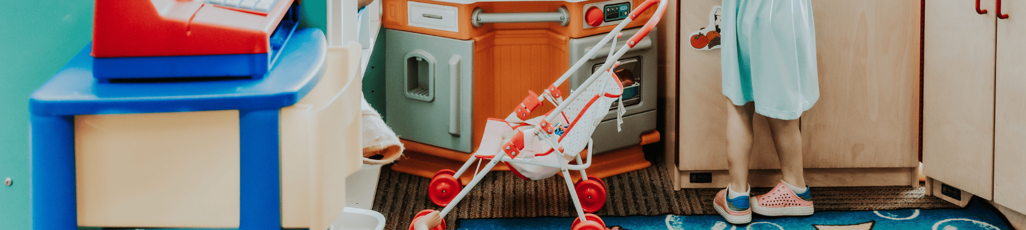 child playing with a stroller